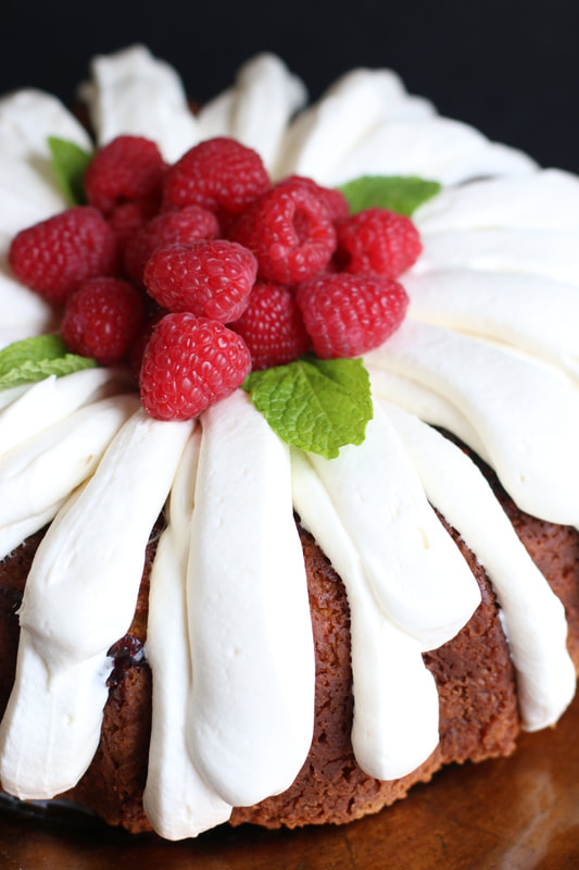 http://www.snowflakesandcoffeecakes.com/uploads/4/9/7/7/497710/white-chocolate-raspberry-bundt-cake_2_orig.jpg